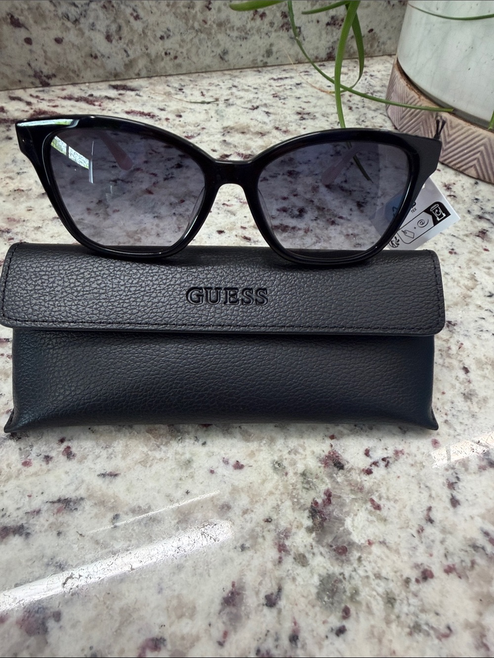 GUESS Black Cat-Eye Sunglasses with Gradient Smoke Lenses, pink arms and ribbon